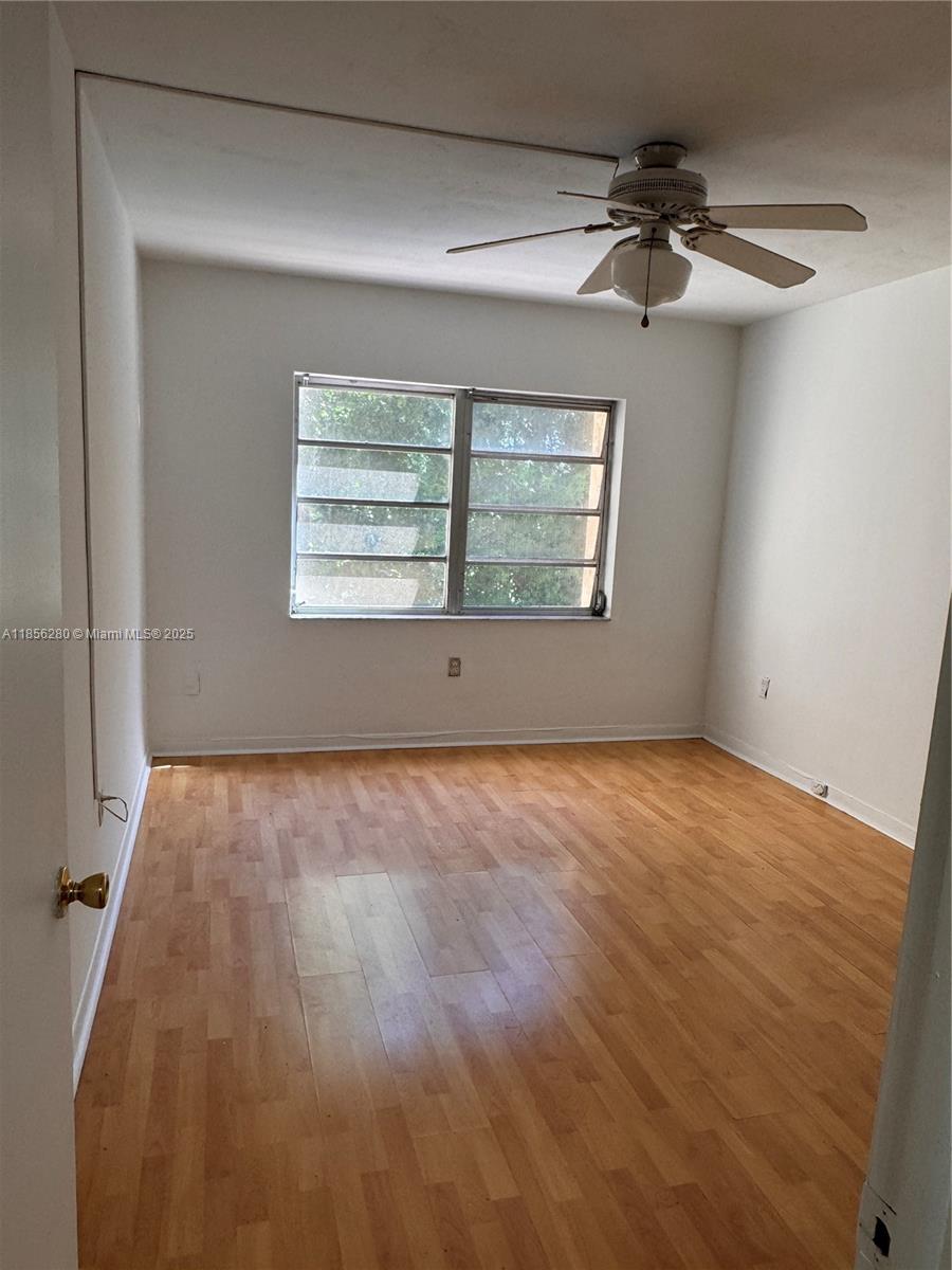 15888 Southwest 95th Avenue, Unit 201 Miami, FL 33157 - Photo 21 of 27 an empty room with a empty space and windows