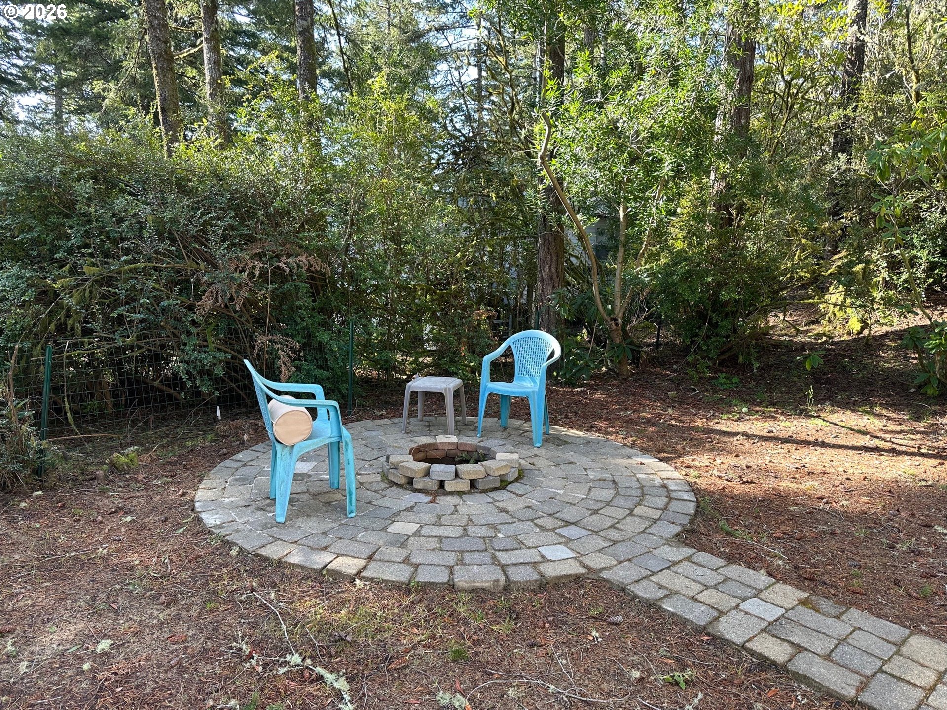 71 Castaway Cove Florence, OR 97439 - Photo 6 of 15 a view of a chair and table in the backyard