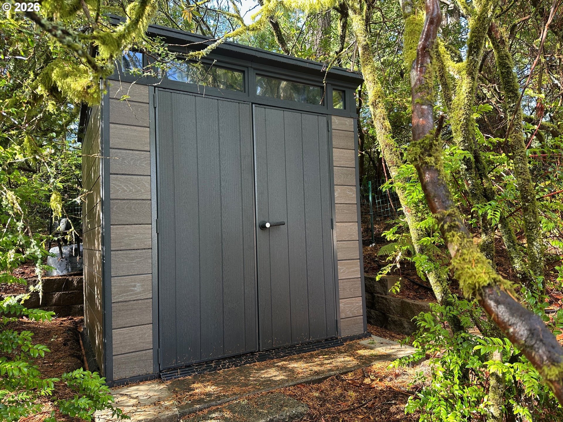 71 Castaway Cove Florence, OR 97439 - Photo 8 of 15 a view of backyard with plants and wooden fence