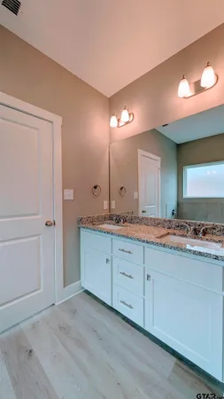 a white toilet sitting next to a sink