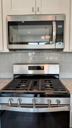 a stove top oven sitting inside of a kitchen