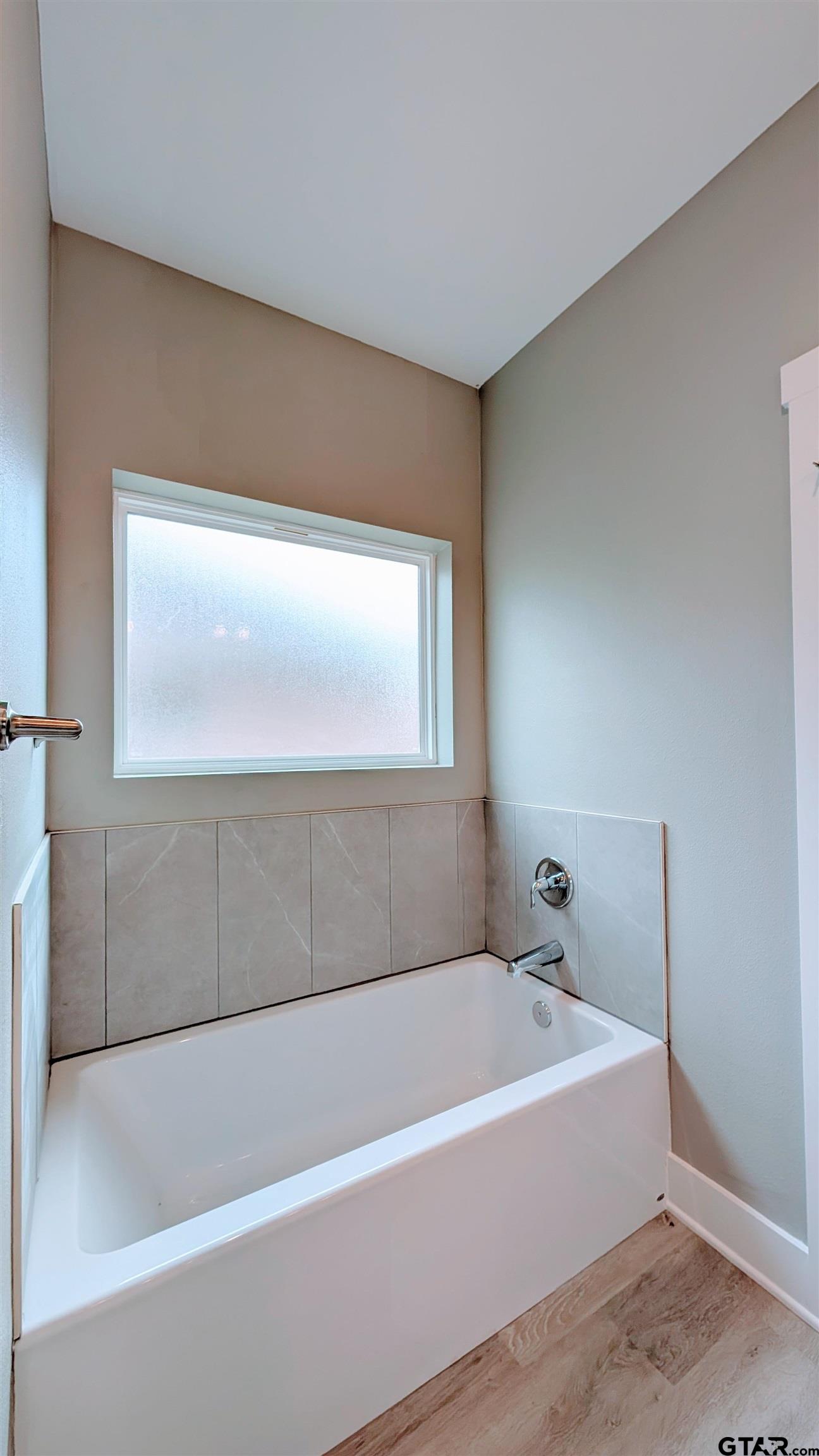 1302 Berkli Cove Whitehouse, TX 75791 - Photo 10 of 20 a bathroom with a bathtub and a window