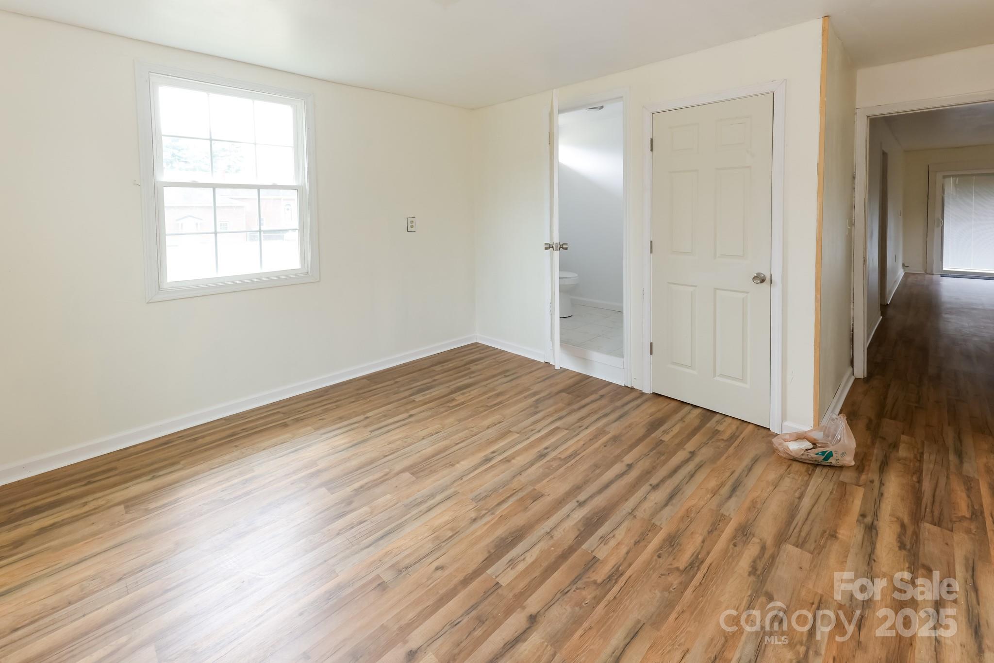 344 Piedmont Road Rutherfordton, NC 28139 - Photo 15 of 25 wooden floor in an empty room with a window