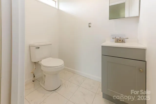 a bathroom with a sink mirror and toilet