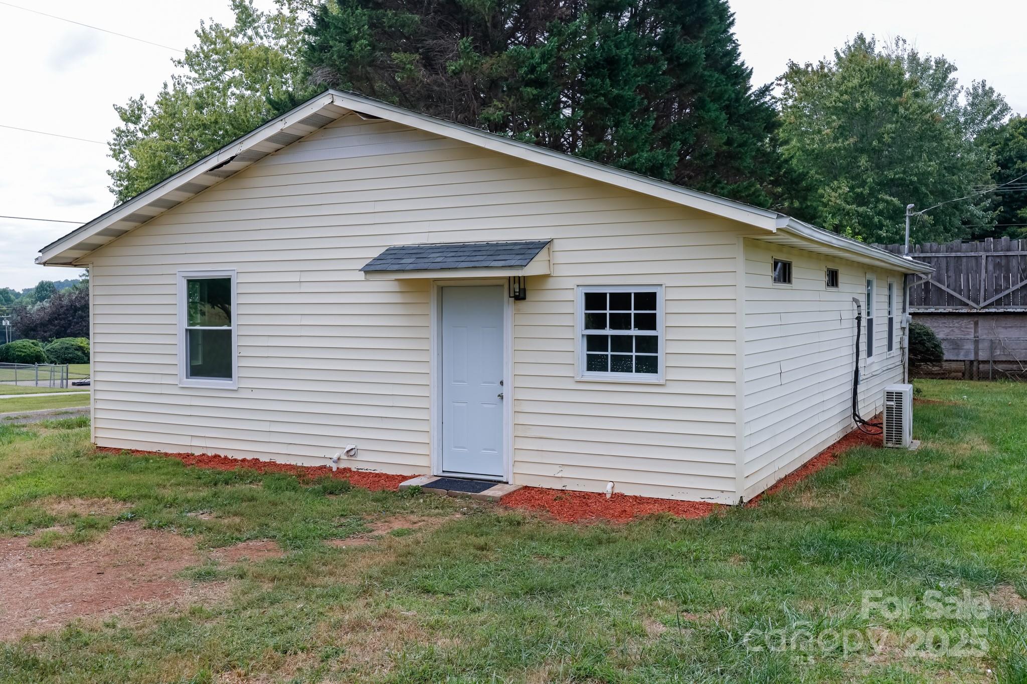 344 Piedmont Road Rutherfordton, NC 28139 - Photo 2 of 25 a view of a white house in front of a yard with large tree