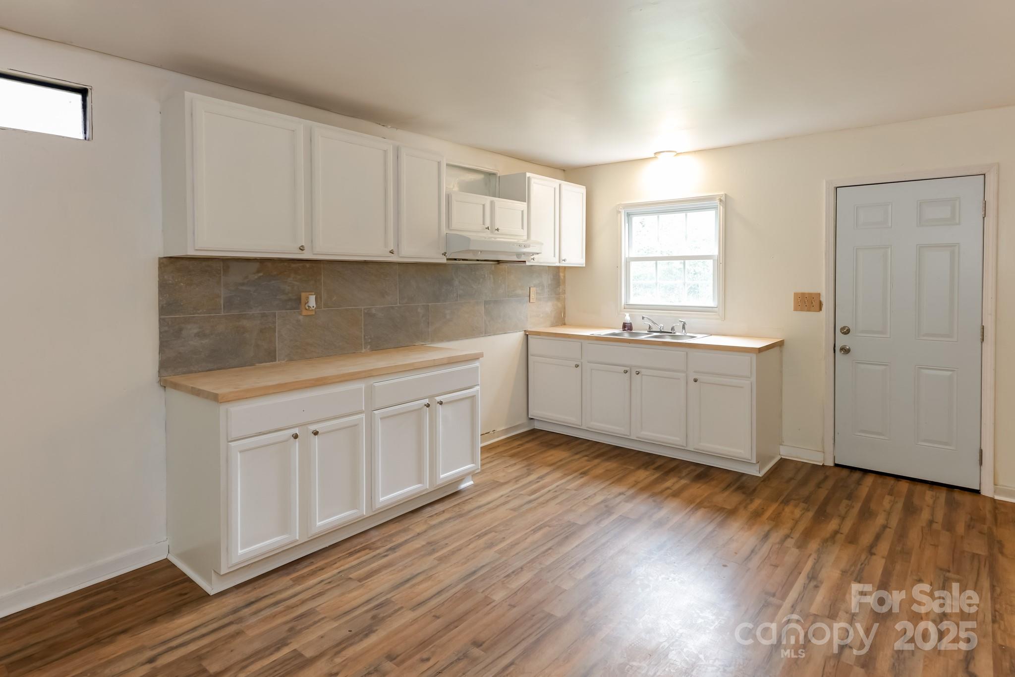 344 Piedmont Road Rutherfordton, NC 28139 - Photo 5 of 25 a view of a kitchen with sink cabinets and wooden floor