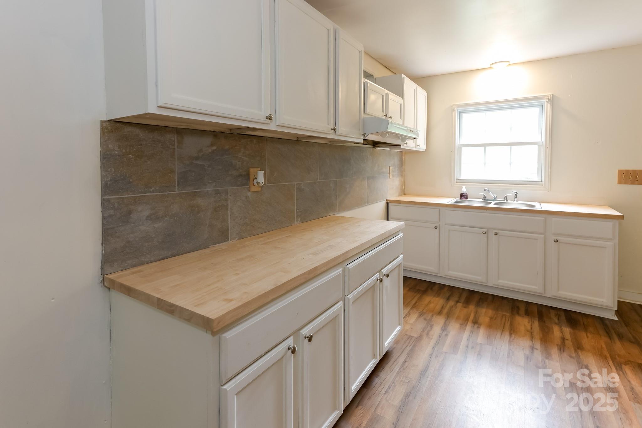344 Piedmont Road Rutherfordton, NC 28139 - Photo 6 of 25 a kitchen with a sink and cabinets