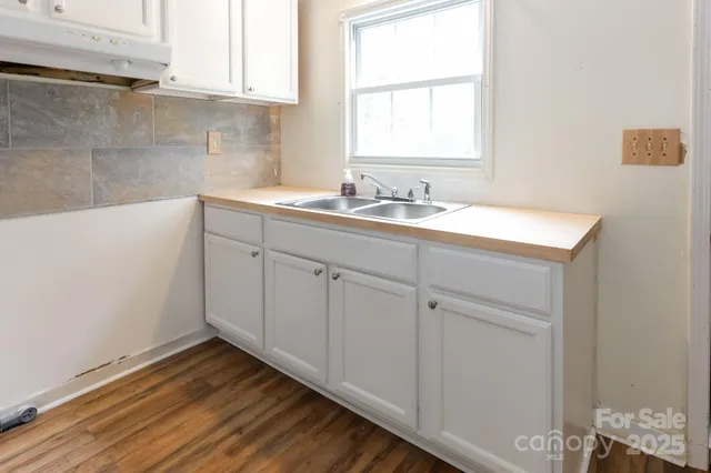 a bathroom with a sink and a window