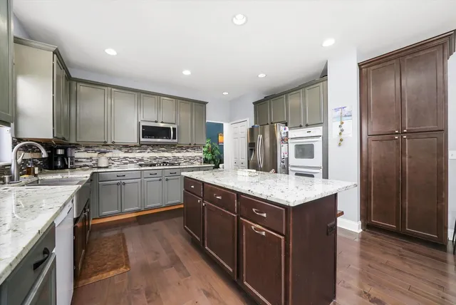 a kitchen with a sink stove and refrigerator