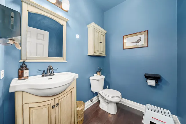 a bathroom with a toilet a sink and mirror