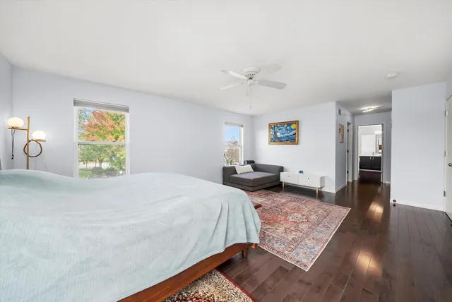 a bedroom with a large bed and a chandelier