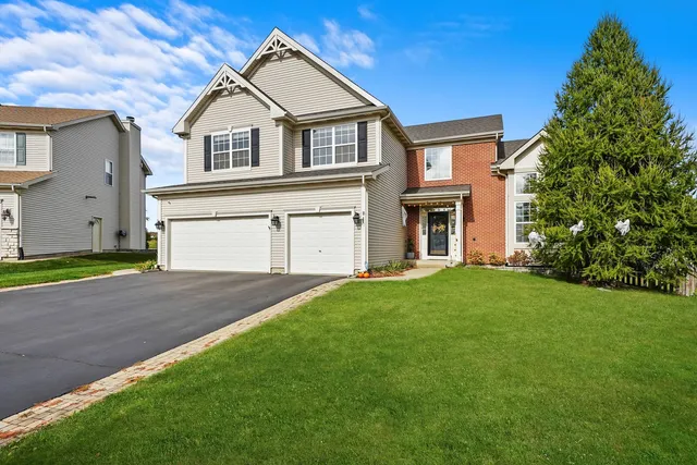 a front view of a house with a garden and yard