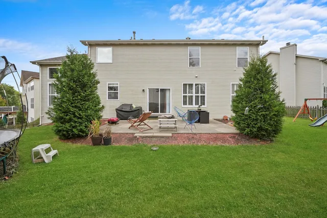 a view of a house with backyard sitting area and garden