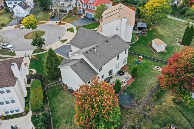 an aerial view of multiple houses with yard