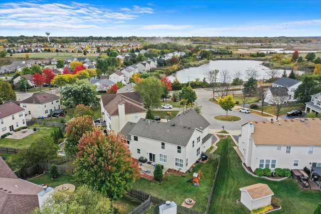an aerial view of a city with lots of residential buildings ocean and mountain view in back