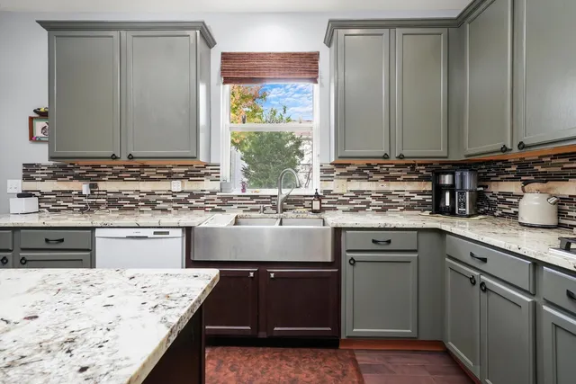 a kitchen with a sink stove and cabinets