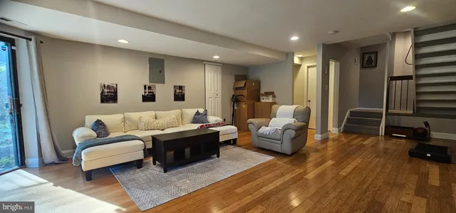 a living room with furniture and wooden floor