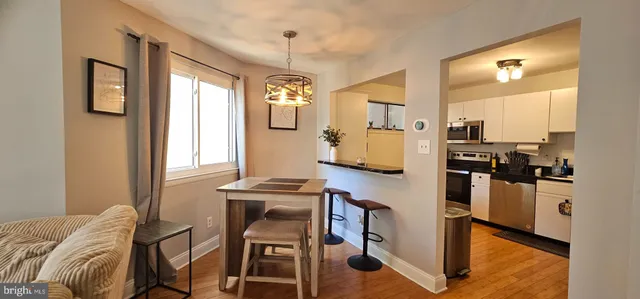 a living room with stainless steel appliances kitchen island granite countertop furniture and a window
