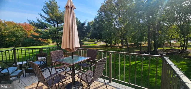 a view of a patio with a table chairs and a backyard