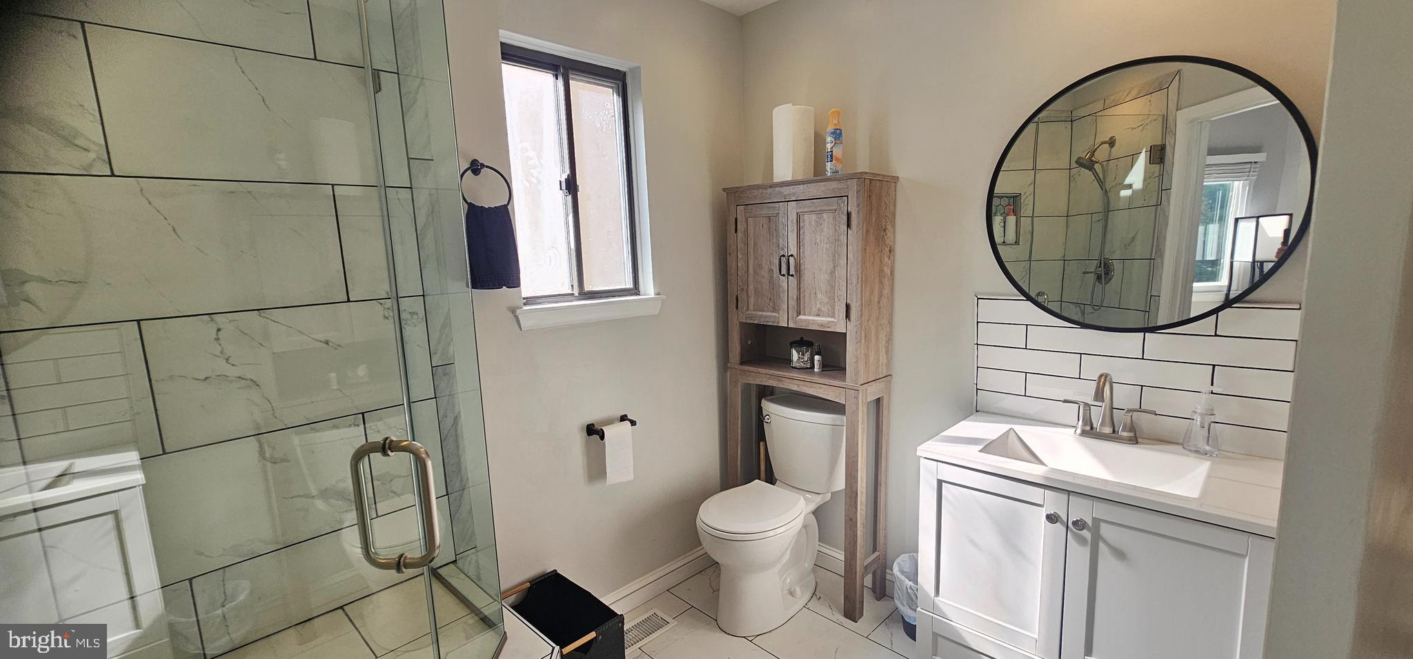 605 Augusta Circle Mount Laurel, NJ 08054 - Photo 21 of 28 a bathroom with a toilet sink vanity and mirror