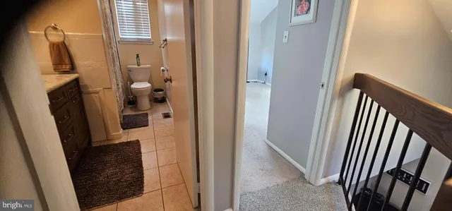 a view of a bathroom from a corridor