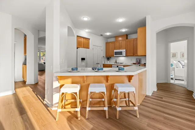 a view of a dining room with furniture and wooden floor