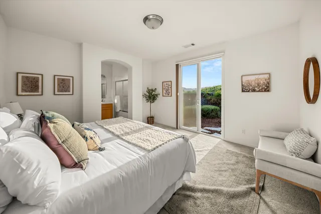 a bedroom with a large bed and a window