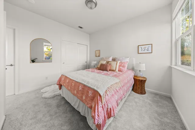 a bedroom with a bed and a lamp