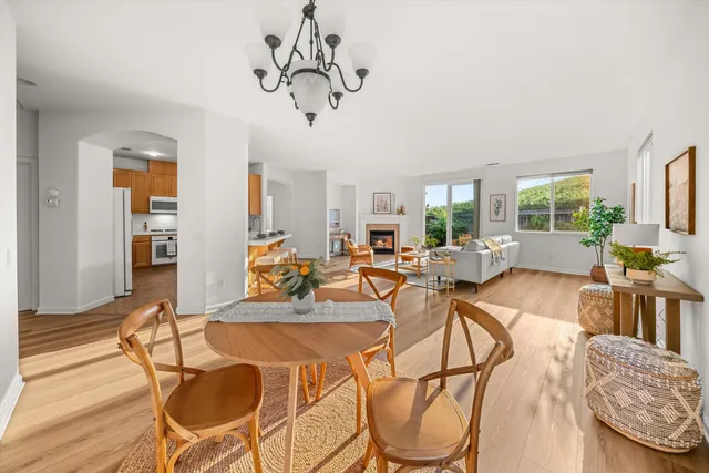 a view of a dining room with furniture a chandelier and wooden floor