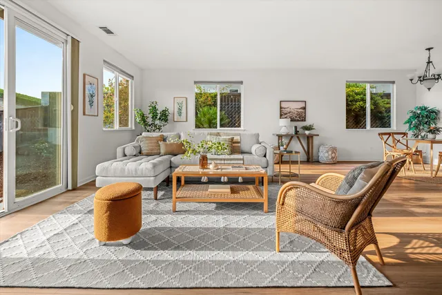 a living room with furniture and a potted plant