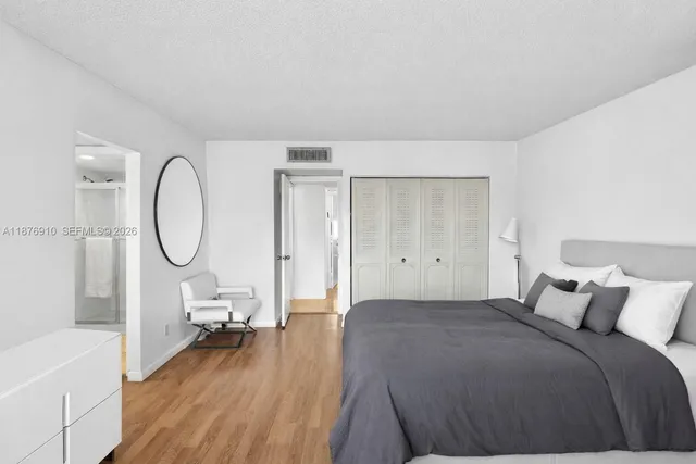 a bedroom with furniture and a flat screen tv