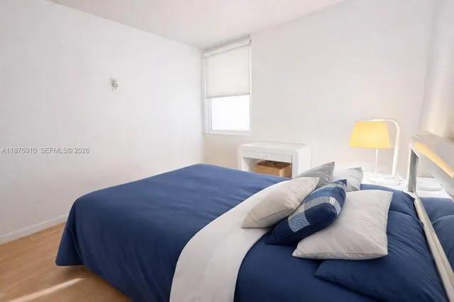 a bathroom with a granite countertop bathtub shower sink vanity and toilet