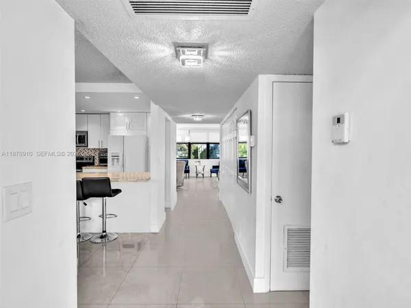 a view of a hallway with wooden floor windows and livingroom view