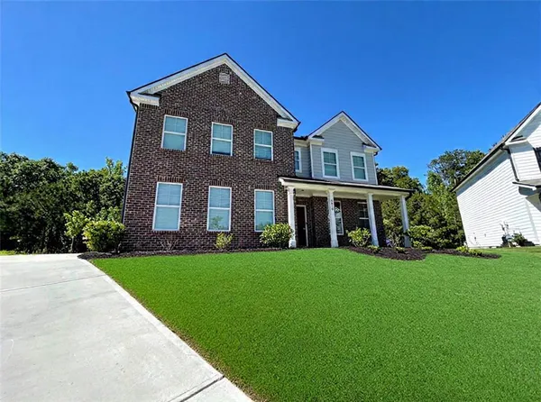 a front view of a house with a yard