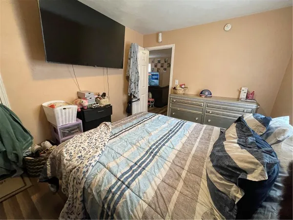 a bed sitting in a bedroom and a flat screen tv