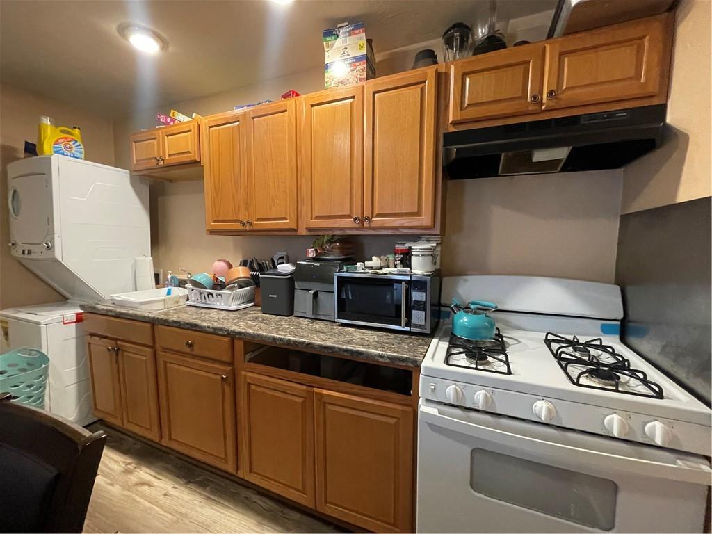 70 South Street Fredericktown, PA 15333 - Photo 7 of 24 a kitchen with stainless steel appliances granite countertop a stove a sink and a microwave