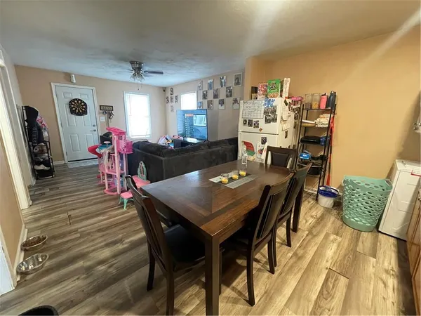 a view of a dining room with furniture and wooden floor