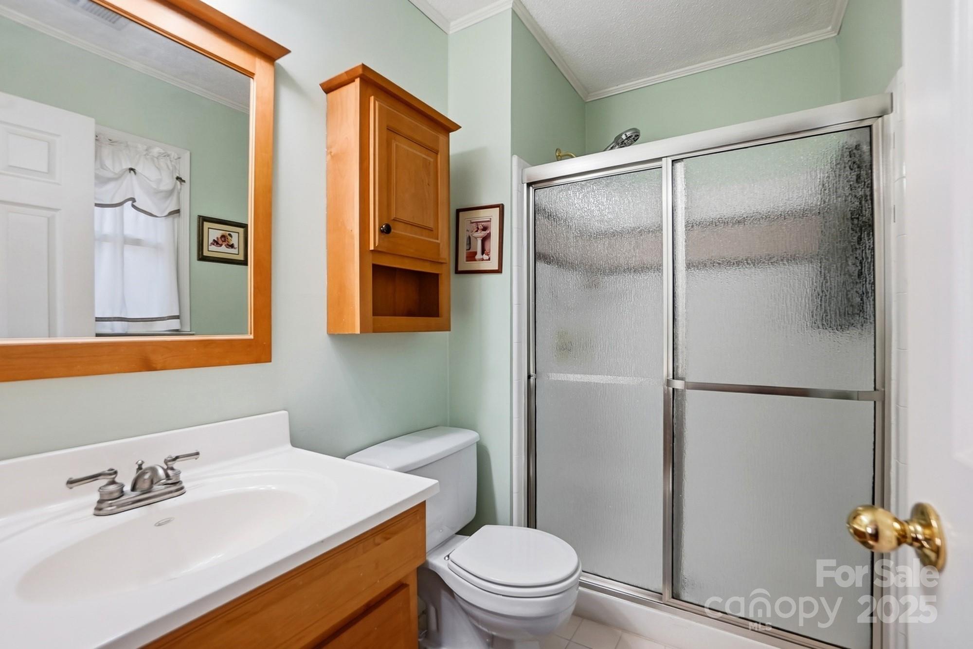 6309 Pineburr Road Charlotte, NC 28211 - Photo 13 of 46 a white toilet sitting next to a bathroom sink