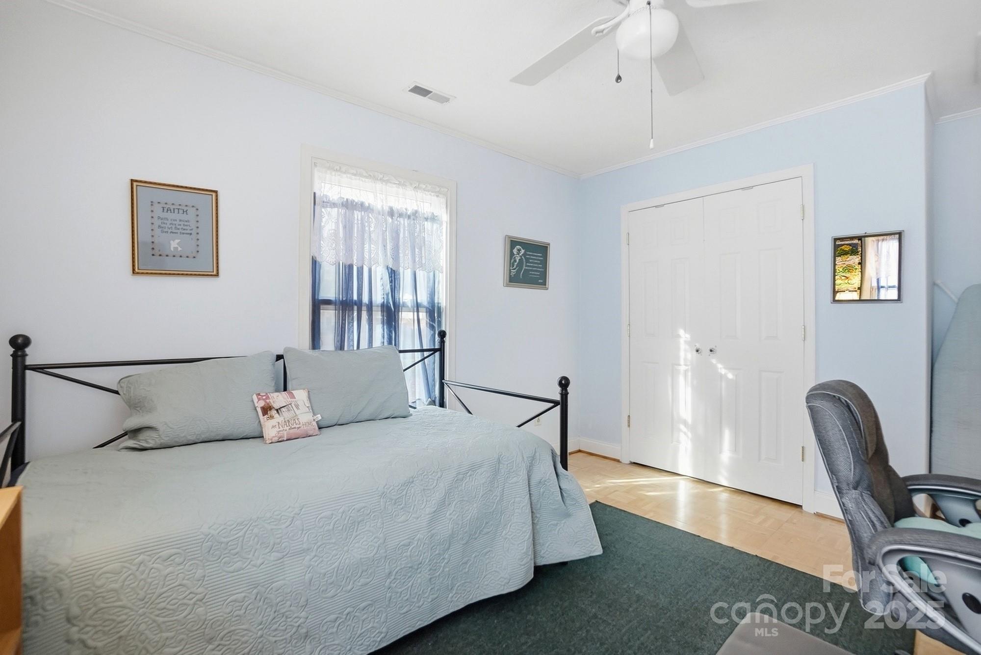 6309 Pineburr Road Charlotte, NC 28211 - Photo 16 of 46 a bedroom with a bed wooden floor and a chair