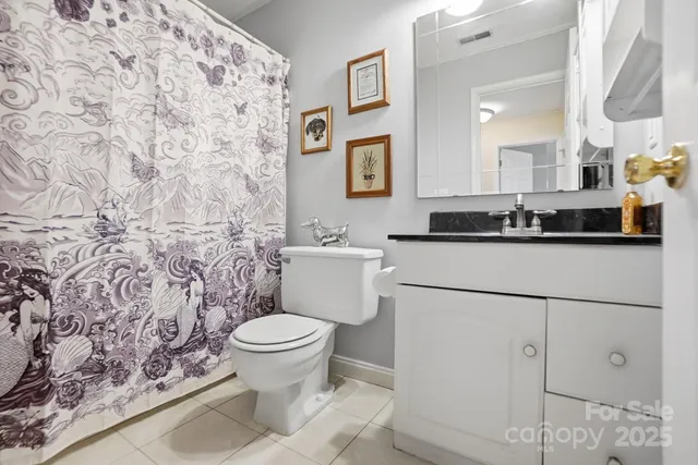 a bathroom with a sink toilet and a mirror