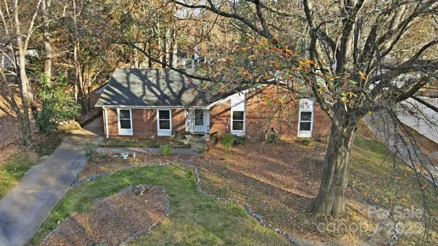 a view of a yard with a house and a large tree