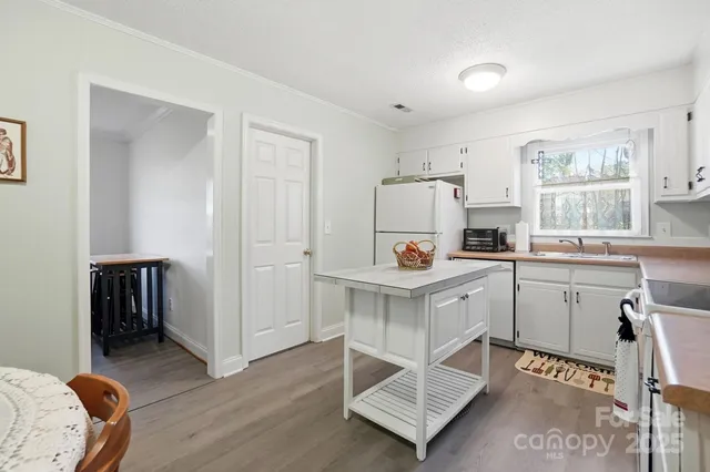 a kitchen with white cabinets and white appliances