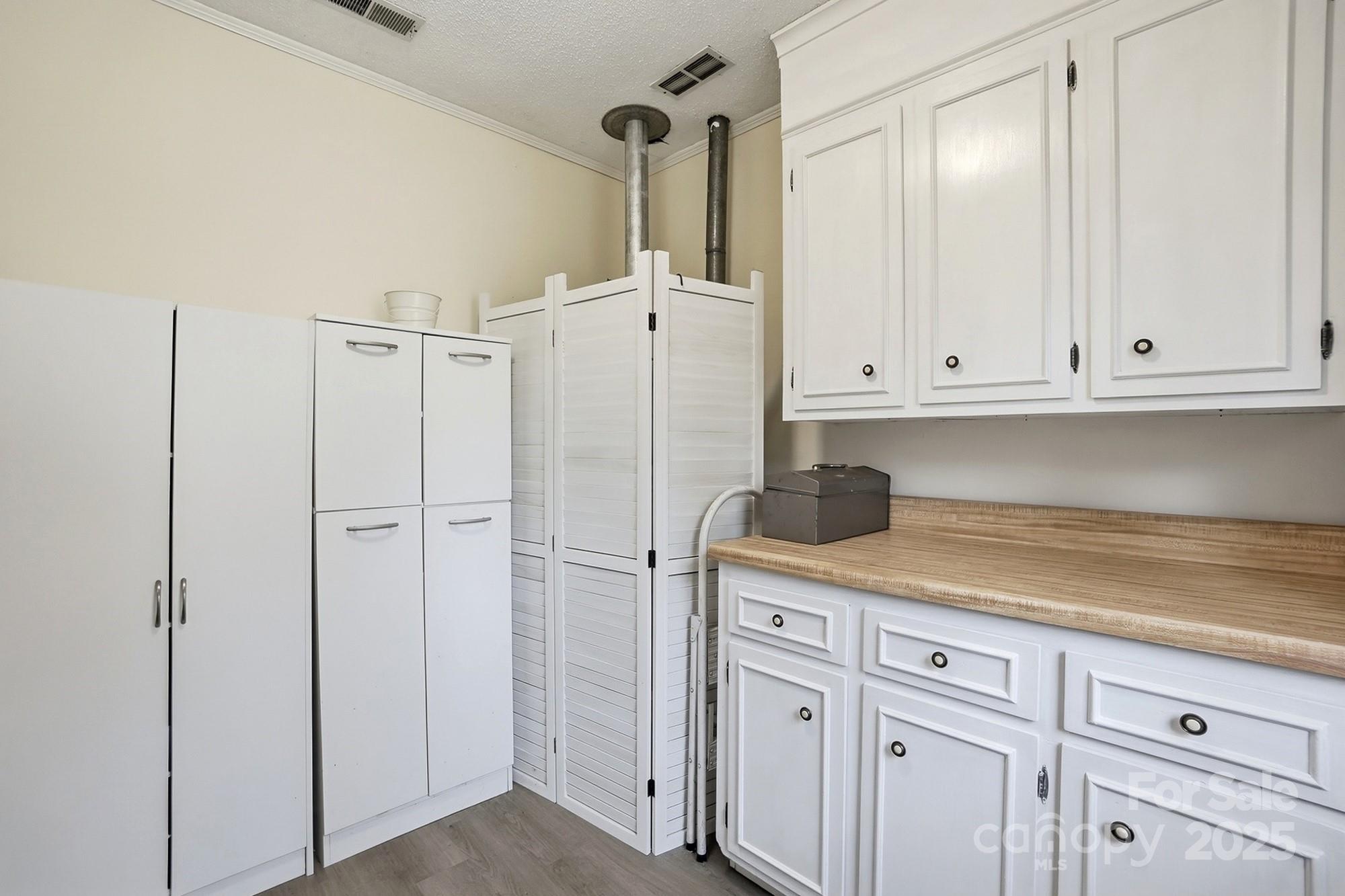 6309 Pineburr Road Charlotte, NC 28211 - Photo 9 of 46 a kitchen with white cabinets and white appliances
