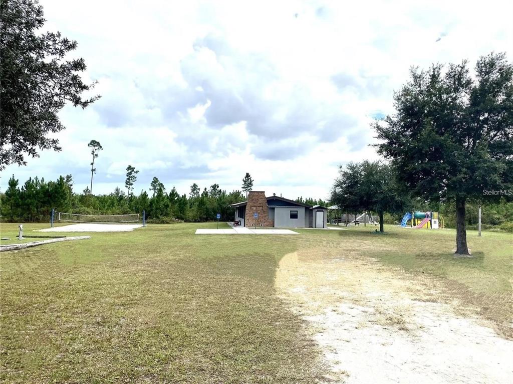 Apricot Avenue Eustis, FL 32736 - Photo 9 of 16 a view of a swimming pool with an outdoor space and seating area