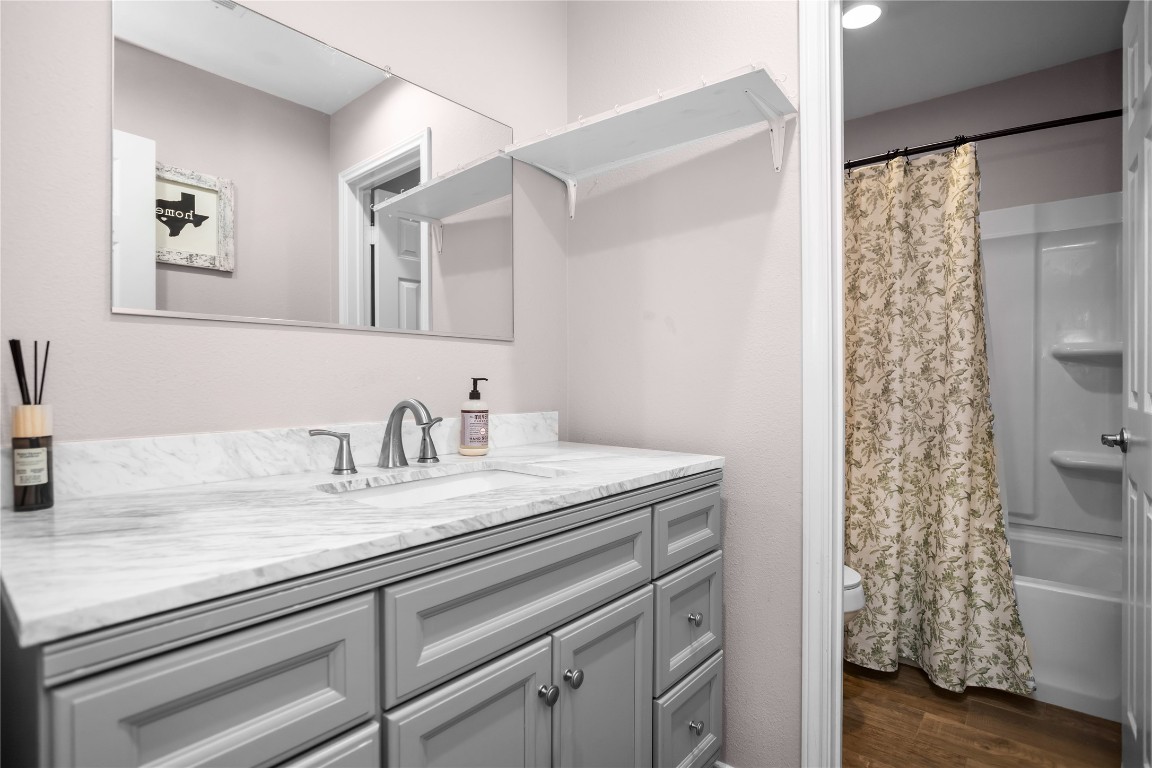 295 Garden City Road Livingston, TX 77351 - Photo 14 of 20 a bathroom with a granite countertop sink and a mirror