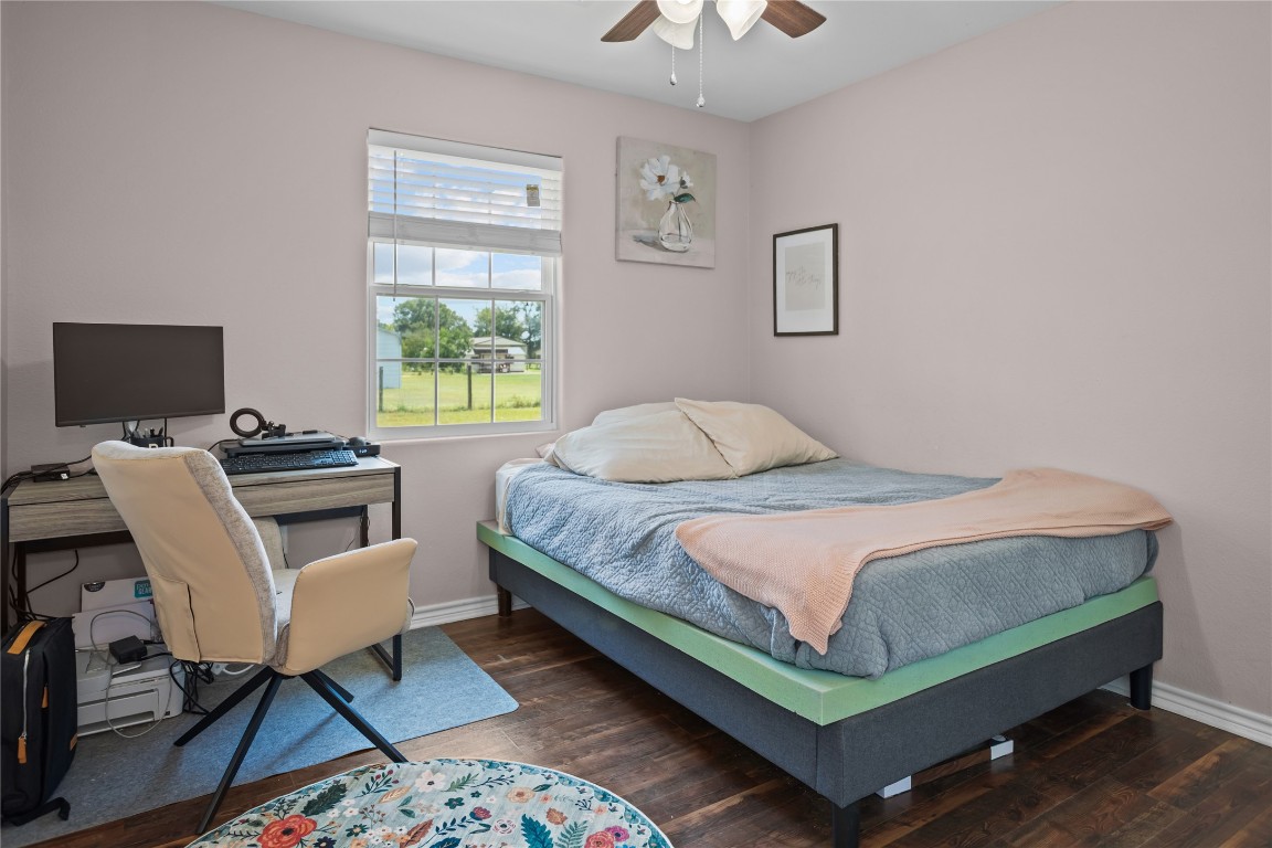 295 Garden City Road Livingston, TX 77351 - Photo 15 of 20 a bedroom with a bed a desk chair and a window