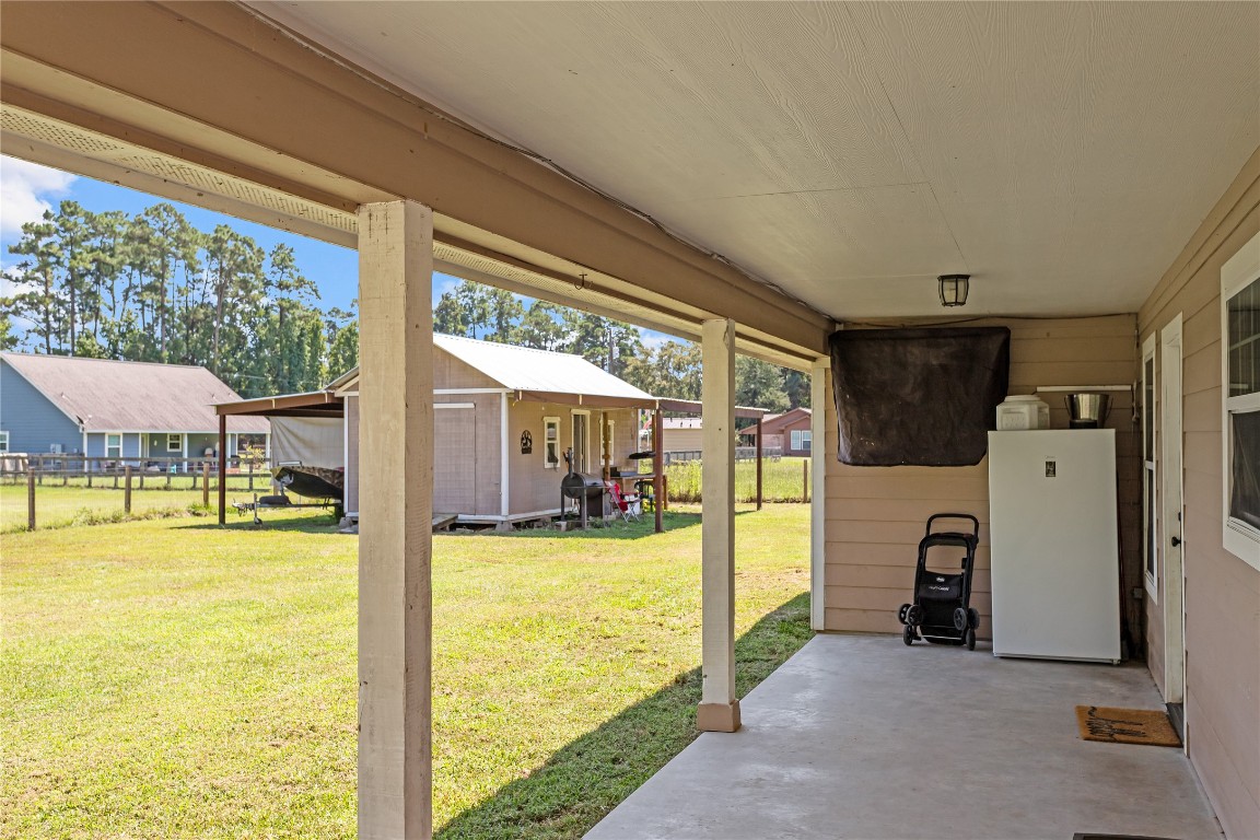 295 Garden City Road Livingston, TX 77351 - Photo 17 of 20 a view of a living room with furniture and a floor to ceiling window