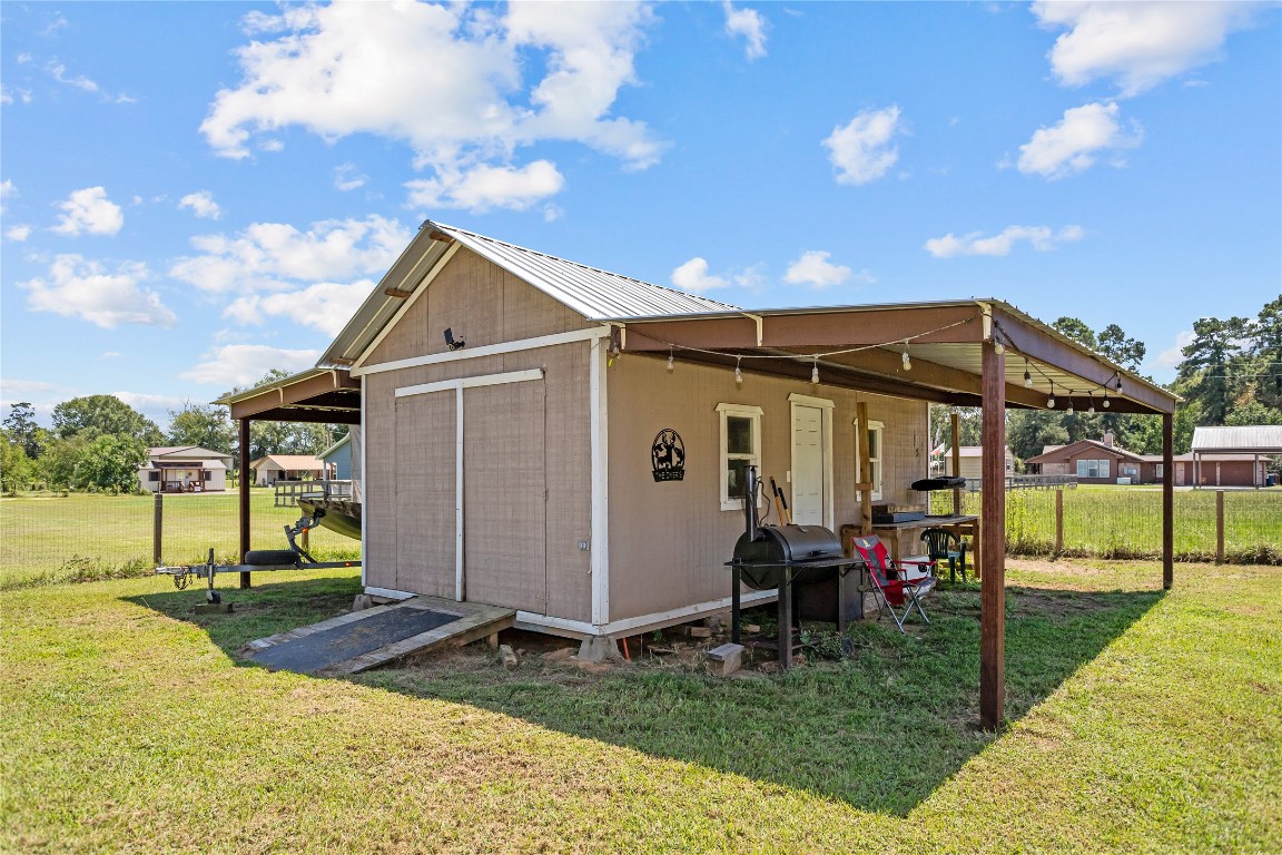 295 Garden City Road Livingston, TX 77351 - Photo 18 of 20 a view of a house with many windows and a big yard