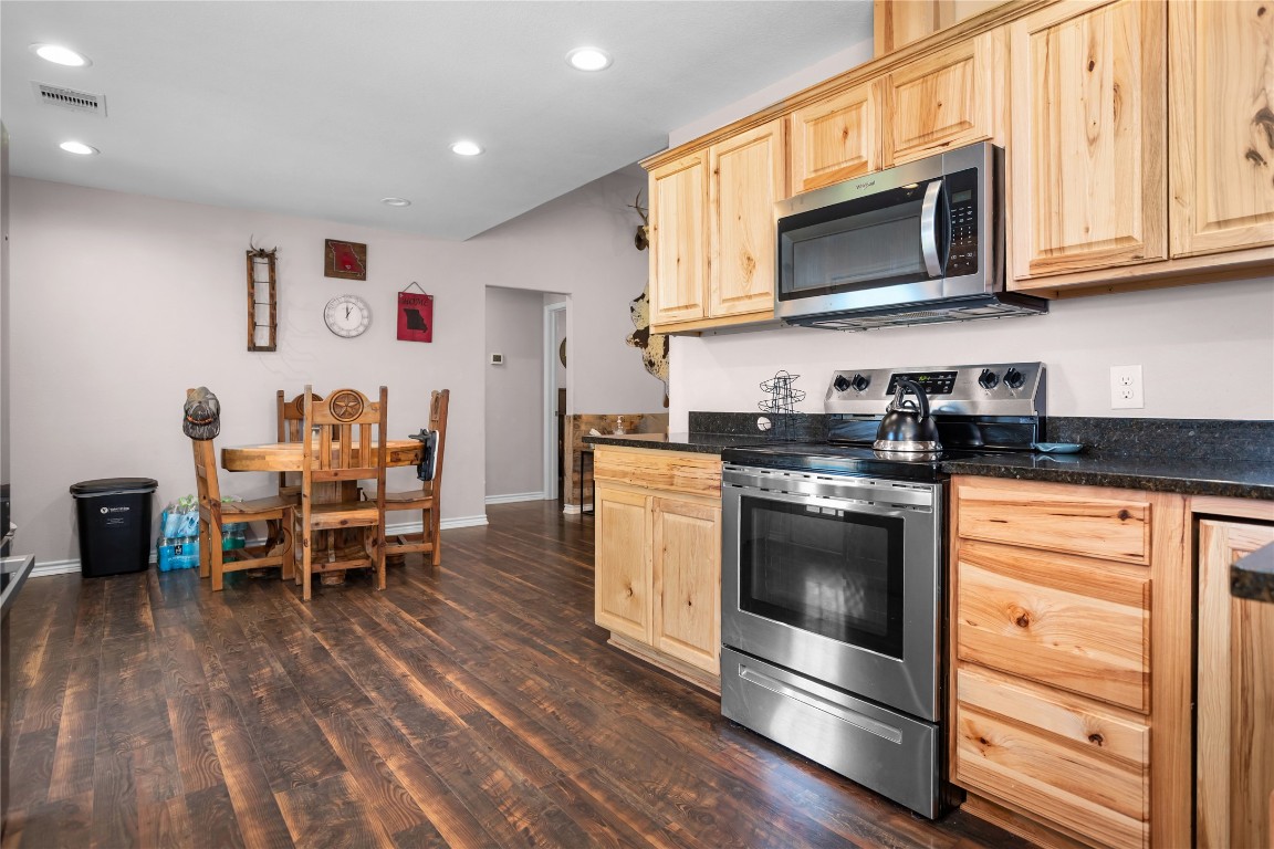 295 Garden City Road Livingston, TX 77351 - Photo 6 of 20 a kitchen with stainless steel appliances granite countertop a stove a microwave a sink and cabinets