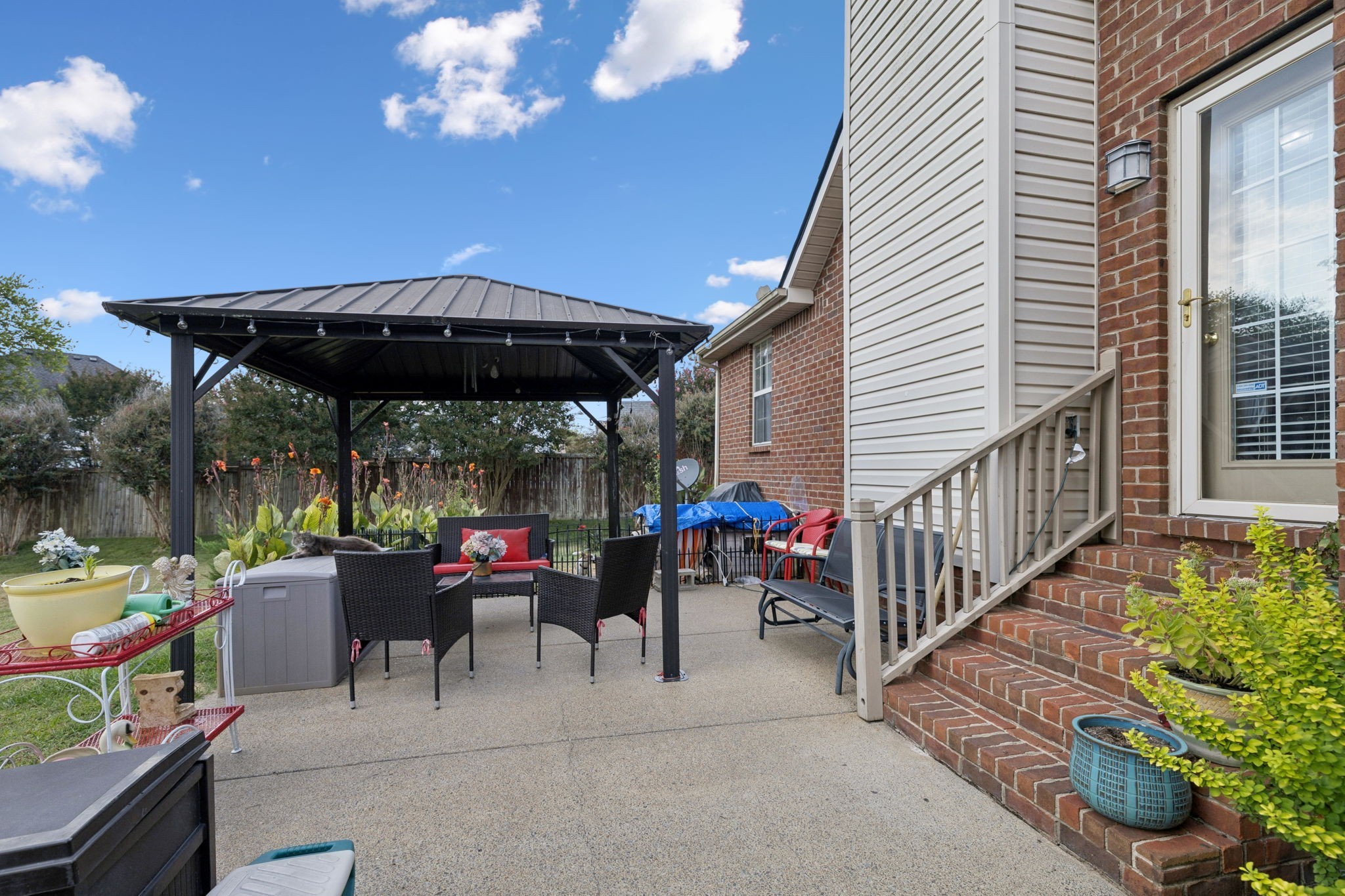114 Falling Branch Court Murfreesboro, TN 37129 - Photo 45 of 69 a view of a patio with a table and chairs under an umbrella